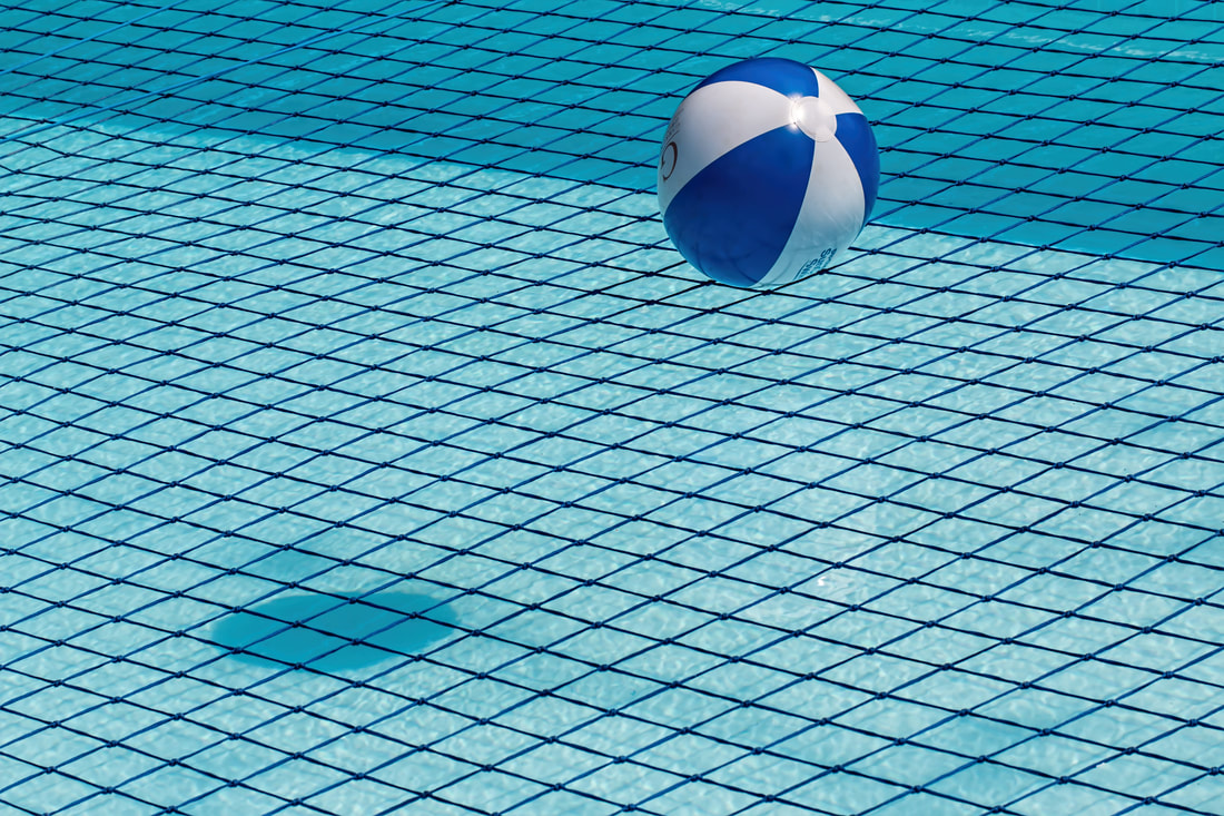 Picture of a plastic ball falling into a pool